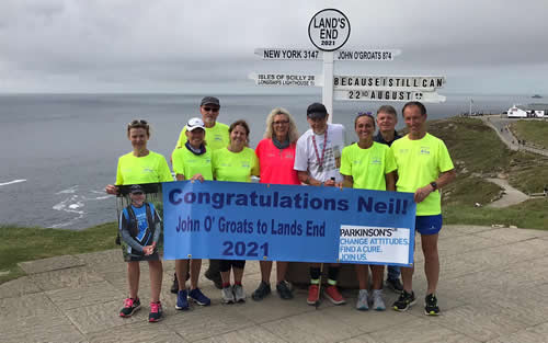Neil Russell with his partner, Nicky and members of Bourton Road Runners celebrate at Land's End - 22nd August 2021