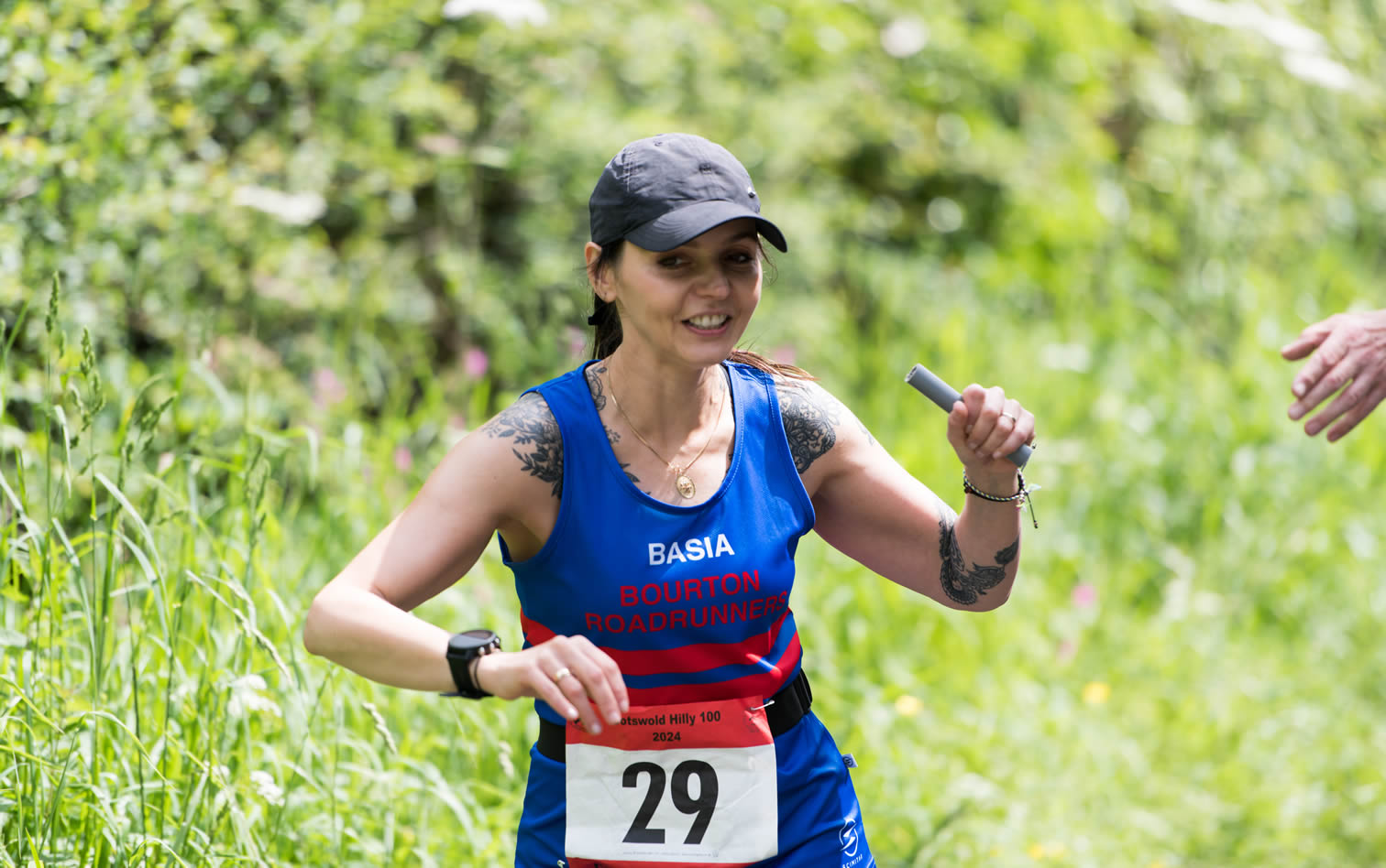 Basia takes the baton at mile 80 hand-over of the Cotswold Hilly 100 Relay - 26-05-2024